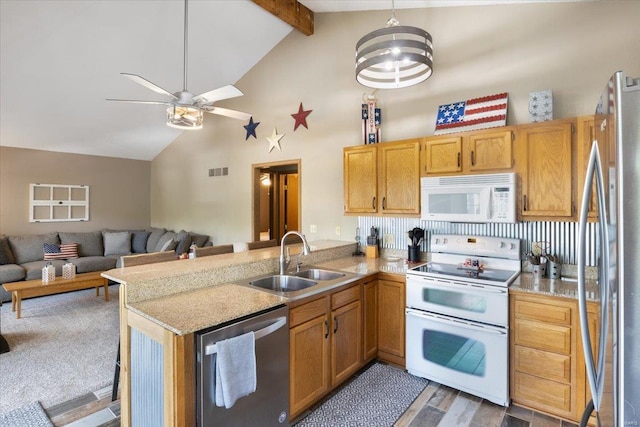 kitchen featuring stainless steel appliances, kitchen peninsula, and sink