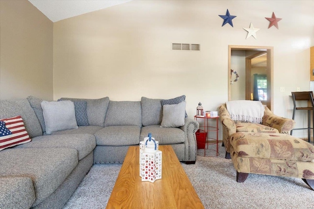 living room with vaulted ceiling and carpet