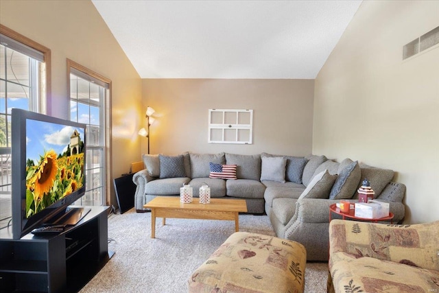 living room with lofted ceiling and light colored carpet