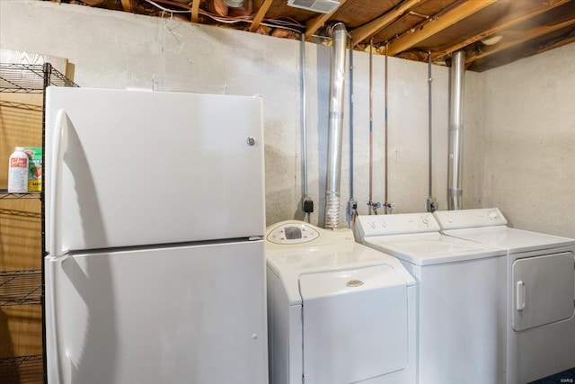 clothes washing area with washer and clothes dryer