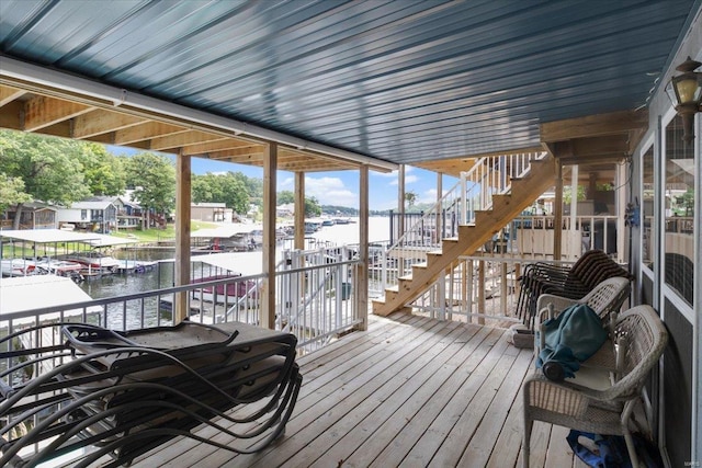 wooden terrace featuring a water view and a dock