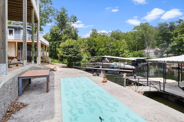 view of swimming pool featuring a water view and a dock