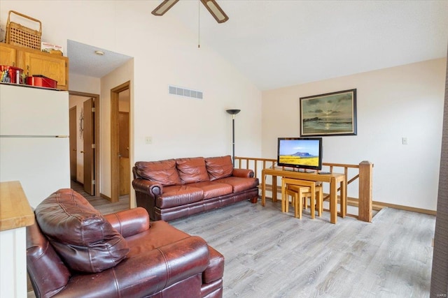 living room featuring ceiling fan, high vaulted ceiling, and light hardwood / wood-style floors