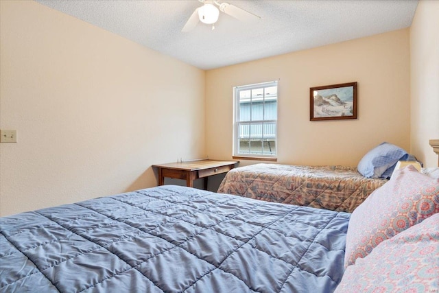 bedroom featuring a textured ceiling and ceiling fan