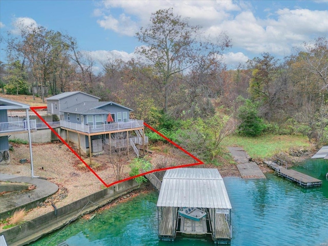 rear view of house featuring a water view