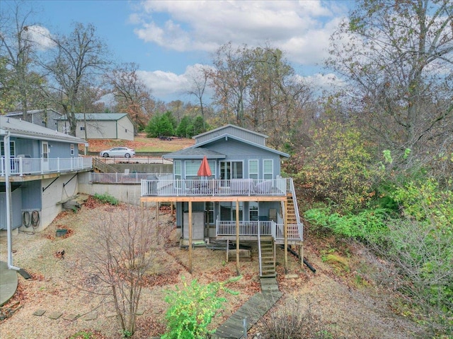 rear view of property with a wooden deck