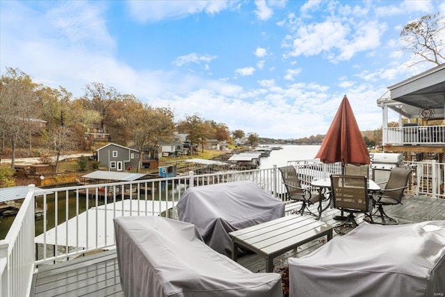 deck with a water view and grilling area