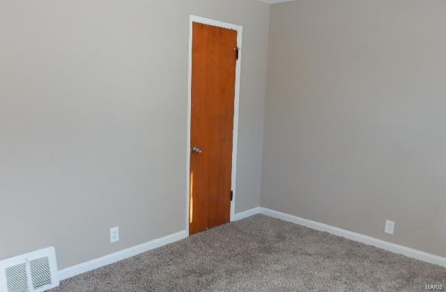 empty room featuring carpet flooring