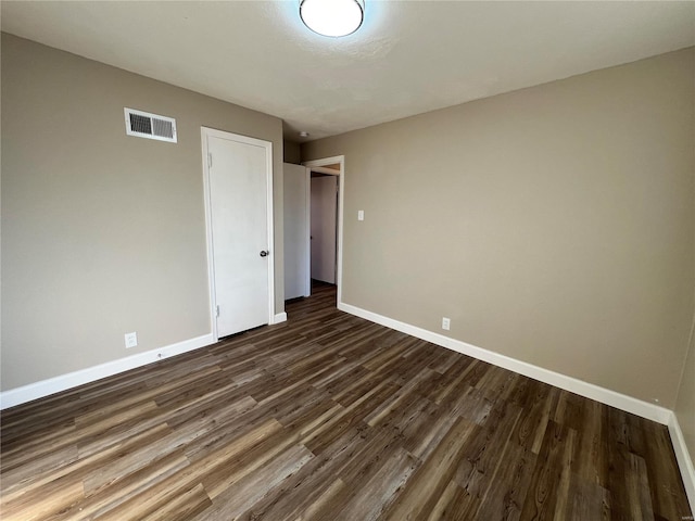 unfurnished bedroom featuring dark hardwood / wood-style floors