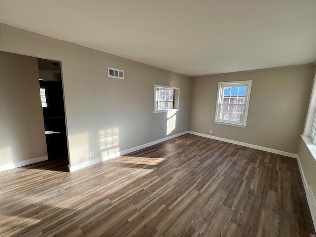 spare room featuring hardwood / wood-style floors and ornamental molding