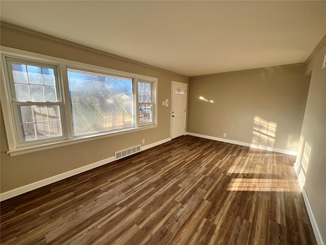 unfurnished room featuring dark wood-type flooring