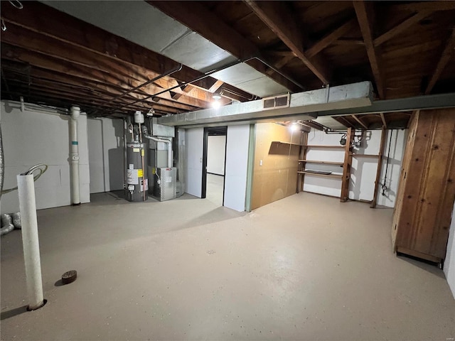 basement featuring heating unit and water heater