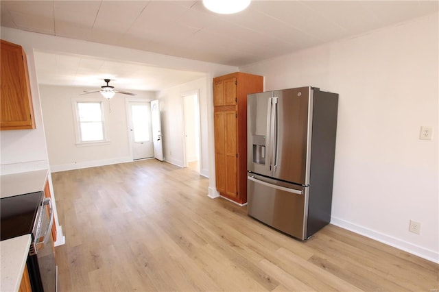 kitchen featuring light wood-type flooring, ceiling fan, and stainless steel appliances