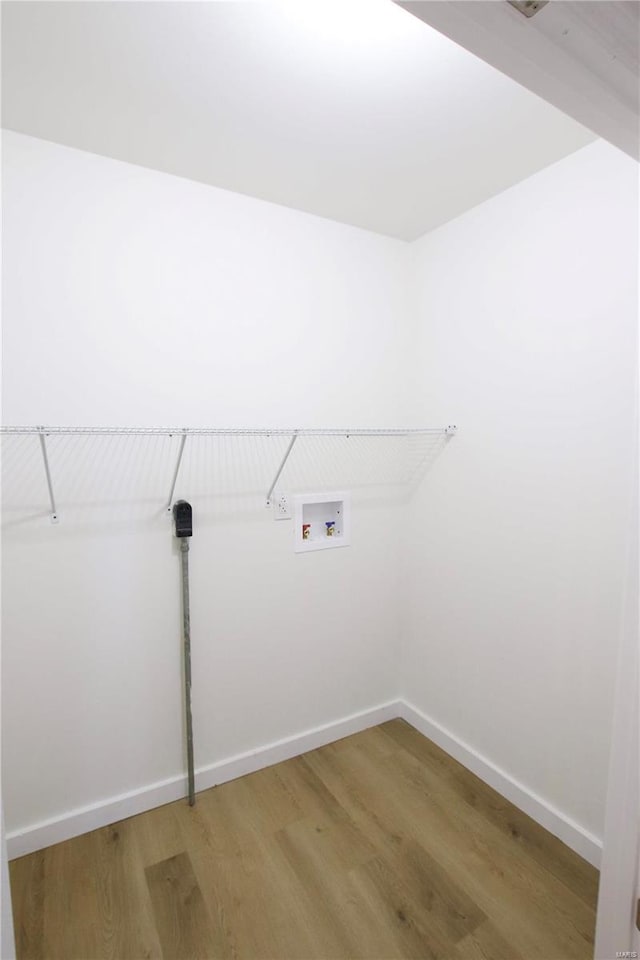 laundry room with hardwood / wood-style floors and hookup for a washing machine