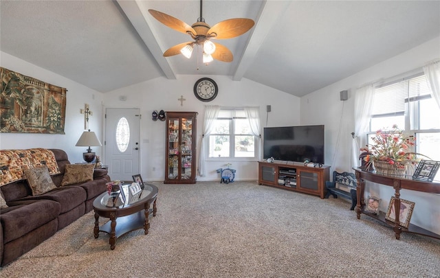 living room with ceiling fan, plenty of natural light, carpet floors, and lofted ceiling with beams