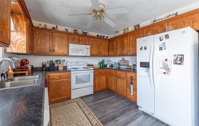 kitchen with ceiling fan, sink, white appliances, a textured ceiling, and dark hardwood / wood-style floors