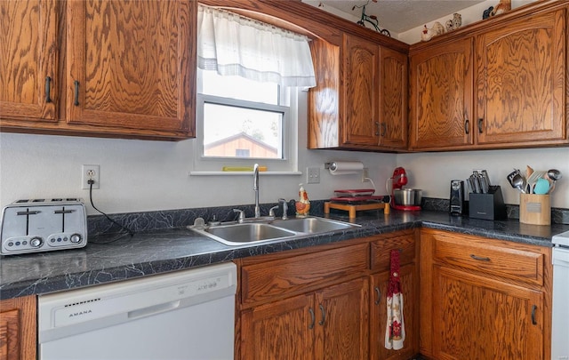 kitchen featuring sink and white dishwasher