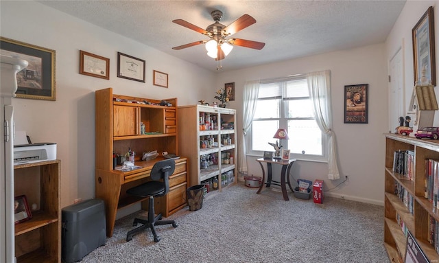 carpeted office with a textured ceiling and ceiling fan