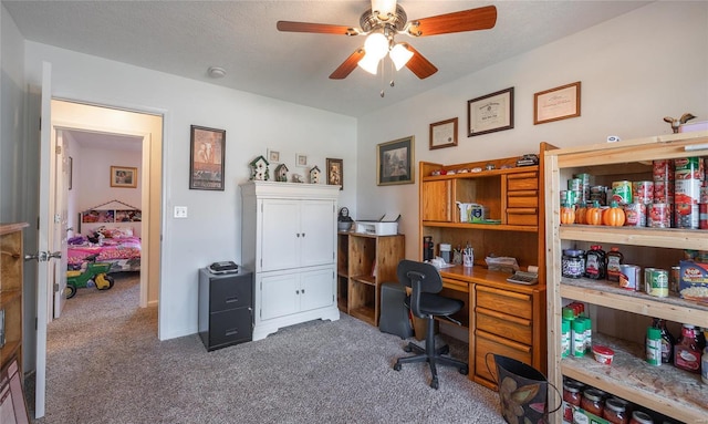 carpeted home office featuring ceiling fan and a textured ceiling