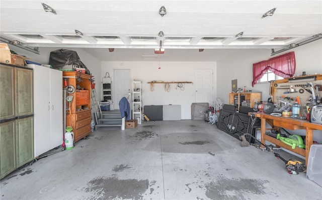 garage with a workshop area and a garage door opener