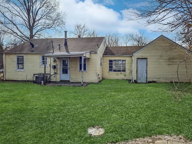 back of house with a lawn