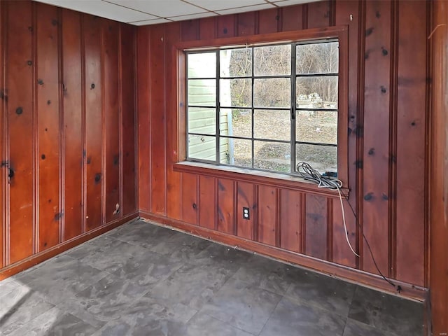 empty room featuring wooden walls