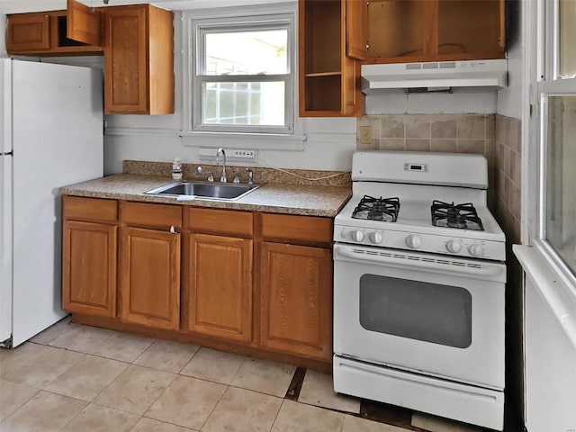 kitchen featuring light tile patterned flooring, sink, white appliances, and decorative backsplash