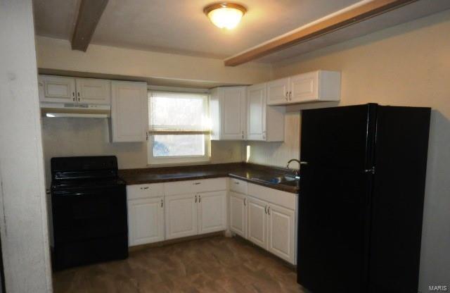 kitchen featuring hardwood / wood-style floors, white cabinetry, sink, black appliances, and beam ceiling