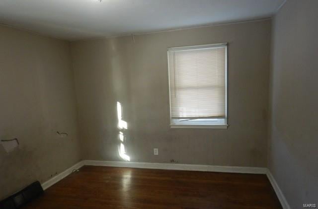 spare room with dark hardwood / wood-style floors