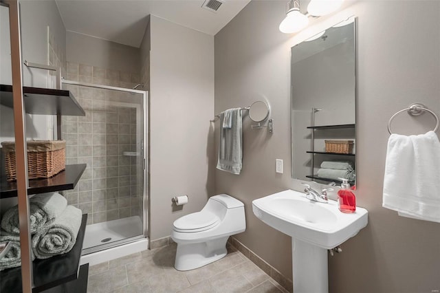 bathroom with a shower with shower door, toilet, and tile patterned flooring