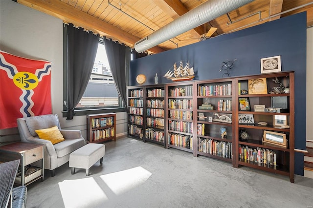 living area featuring concrete floors, beam ceiling, and wood ceiling