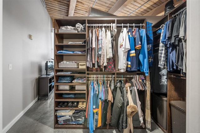 spacious closet featuring beam ceiling