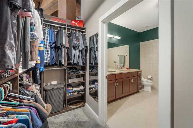 spacious closet with sink and light tile patterned flooring