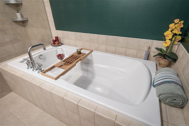 bathroom featuring a relaxing tiled tub and tile patterned flooring