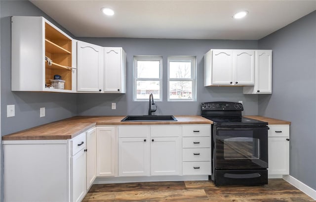 kitchen with butcher block countertops, white cabinetry, sink, black range with electric cooktop, and dark wood-type flooring