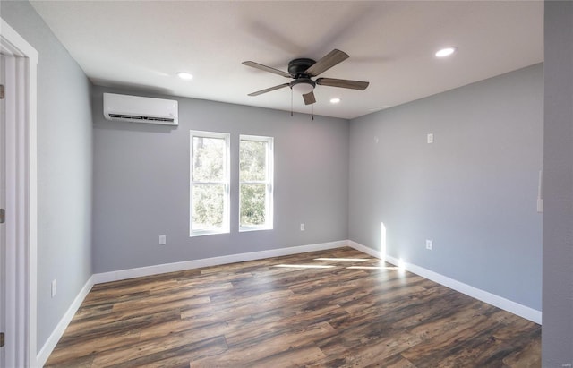 spare room featuring dark wood-type flooring, ceiling fan, and a wall mounted AC