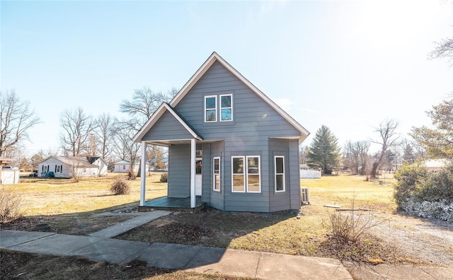 view of front of home with central AC unit and a front lawn