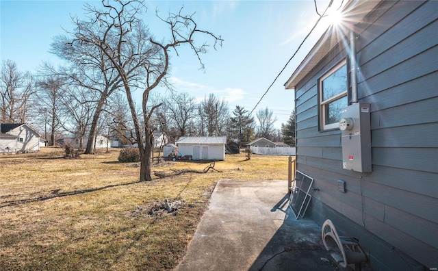 view of yard featuring an outbuilding and a patio area