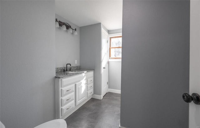 bathroom with baseboards and vanity