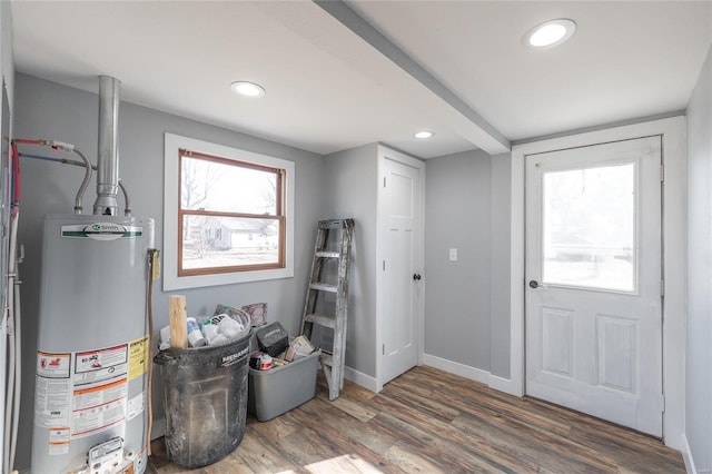 entrance foyer with water heater, baseboards, wood finished floors, and recessed lighting