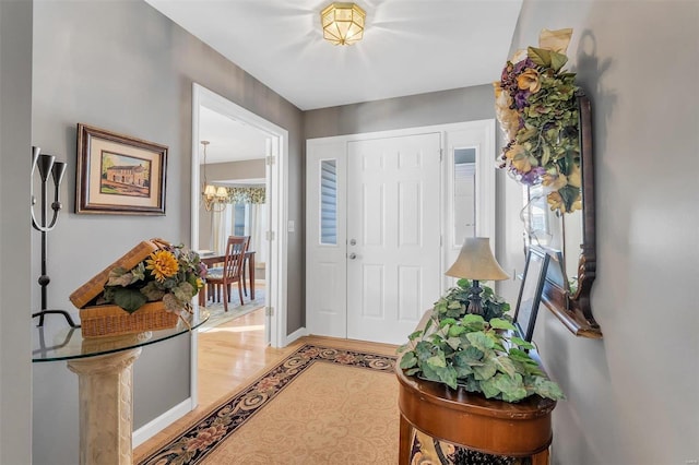 entrance foyer featuring light hardwood / wood-style flooring and an inviting chandelier