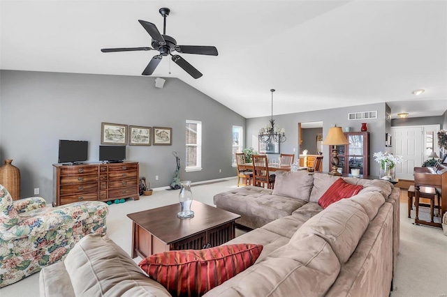 living room with vaulted ceiling, ceiling fan with notable chandelier, and light colored carpet