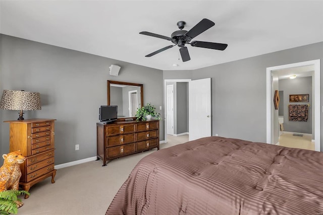 bedroom featuring light colored carpet, connected bathroom, and ceiling fan