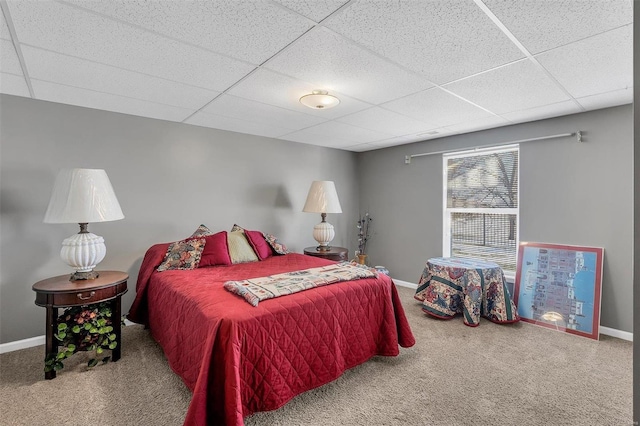 bedroom featuring a paneled ceiling and carpet