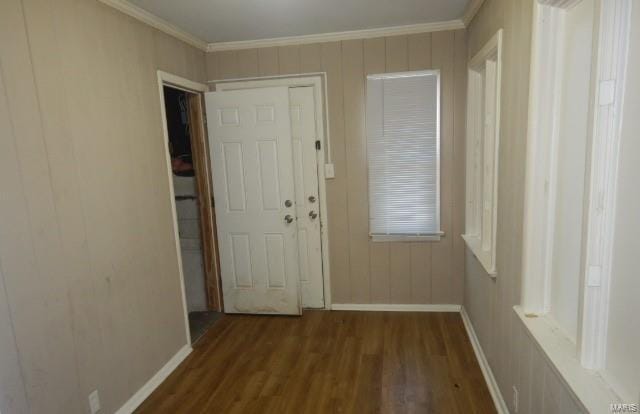 doorway featuring ornamental molding and dark hardwood / wood-style flooring