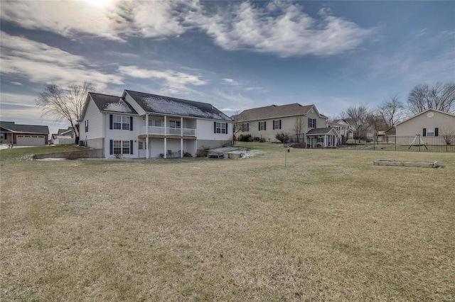 rear view of property featuring a yard