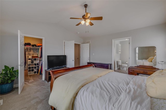 carpeted bedroom featuring a spacious closet, a closet, ceiling fan, connected bathroom, and lofted ceiling