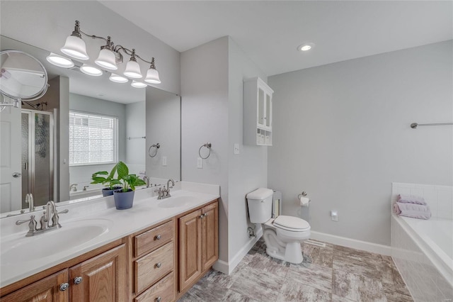 bathroom featuring a relaxing tiled tub, toilet, and vanity