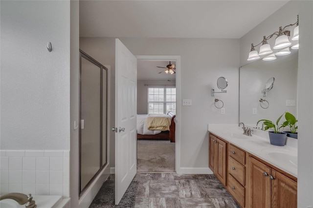 bathroom with a shower with door and vanity