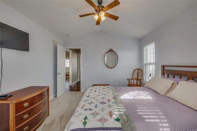 bedroom with light carpet, lofted ceiling, and ceiling fan